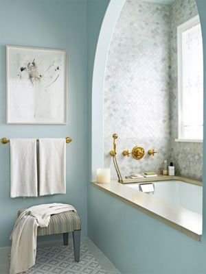 blue bathroom gold fixtures gold towel rack arched bathtub ceiling ornate floor tiles bathtub tiles.jpg